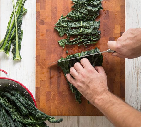 man chopping kale